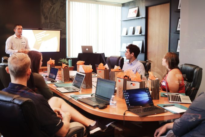 Employees streamlining and consolidating business operations using Professional Services Automation (PSA) software for improved efficiency and coordination